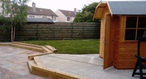 Ranch Fencing Sleeper Steps with a patio and lawn